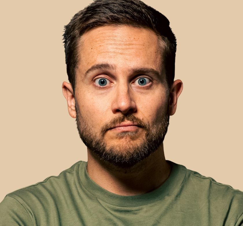 Main event graphic for the Zoltan Kaszas: WORLDWIDE(ish) Tour that features a headshot of the comedian on a tan background.
